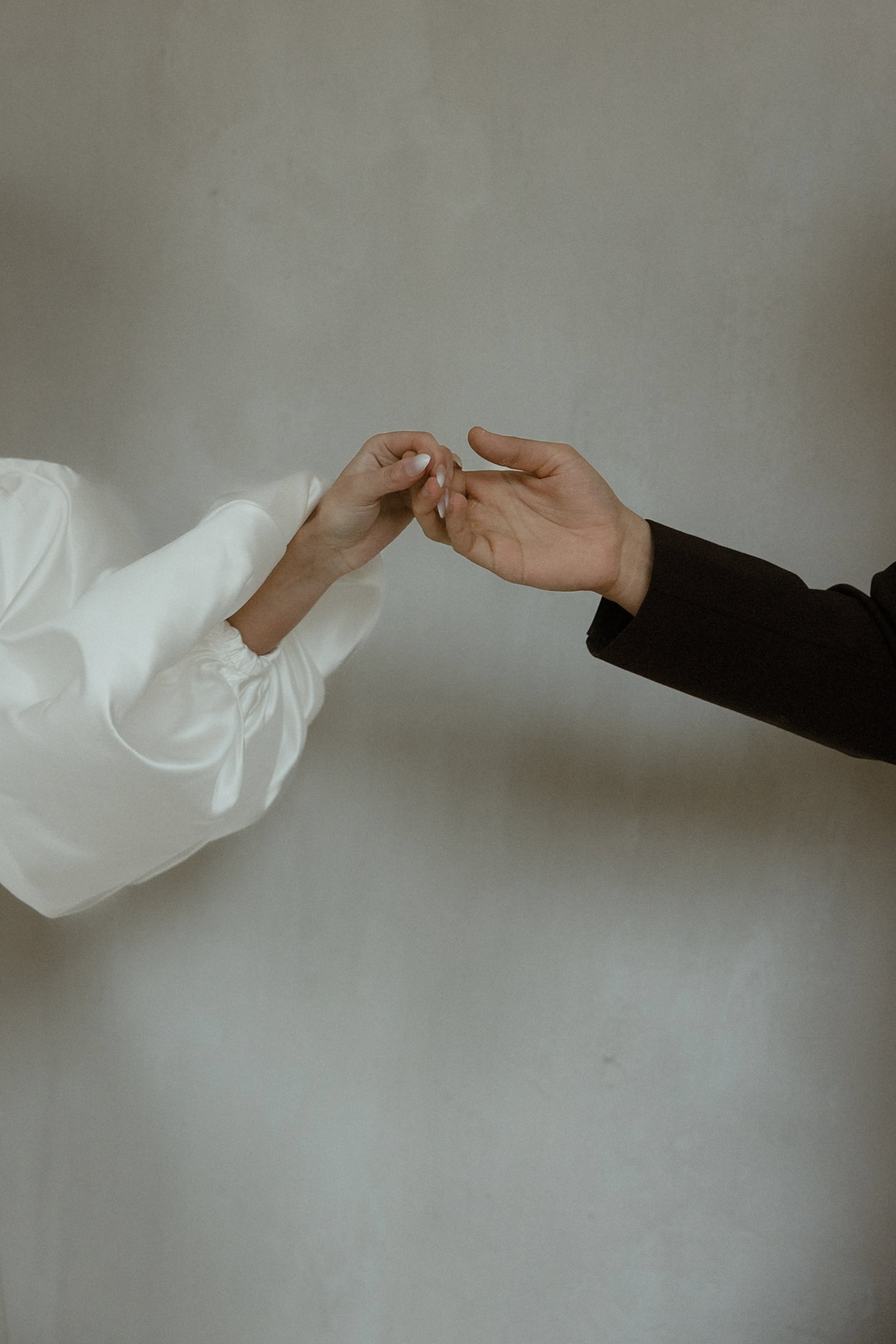 Hands reaching toward each other during a wedding session in the Algarve, Portugal